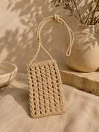 Beige handmade paper yarn crochet phone bag with a long crossbody strap.