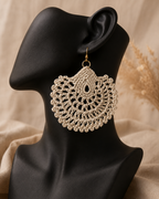 beige round crochet statement earring displayed on a black jewellery bust with a gold-tone stainless steel hook.