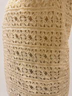 Detailed back view of the cream crochet vest showing its repeating openwork pattern and softly defined stitch texture
