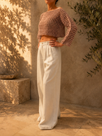 Three-quarter front view of the handmade dusty mauve crochet crop top showing its cropped length and relaxed sleeves.