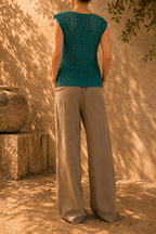 Back view of the handmade emerald green crochet top showing the openwork stitch pattern and decorative edging.
