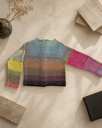 Back flat-lay view of the handmade crochet cardigan with extended sleeves and individually composed colour transitions.