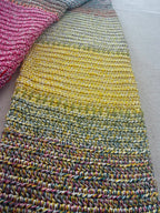 Close-up of the cardigan sleeve showing gradual transitions through yellow, blue, green and deeper blended tones.