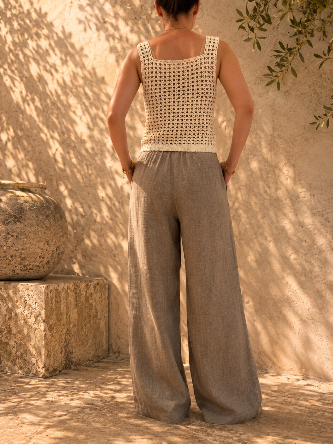 Back view of the handmade ivory crochet tank top showing its wide straps and higher back neckline.