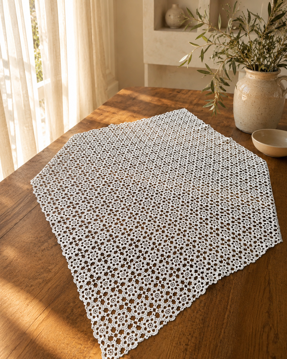 Large 80 cm square white crochet table topper displayed on a wooden table, showing its nineteen-by-nineteen floral motif arrangement.