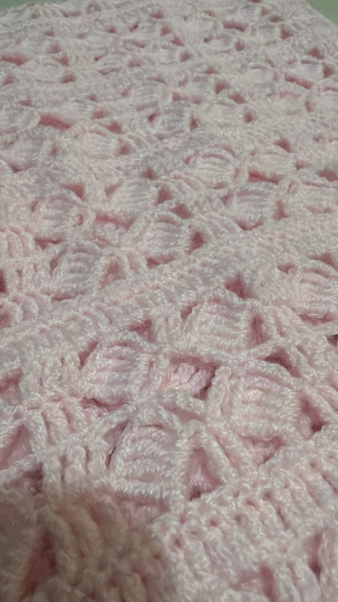 Close-up of the light pink Size 2 crochet vest showing its durable acrylic yarn and decorative openwork texture.
