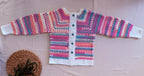 Full flat-lay front view of the multicolour crochet cardigan showing its long sleeves, button placket, cuffs and white hem.