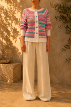Front view of the multicolour striped crochet cardigan showing its round neckline, white button placket and relaxed silhouette.