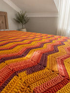 Close-up of the rhythmic chevron rows, textured crochet stitches and natural Batik yarn colour changes.