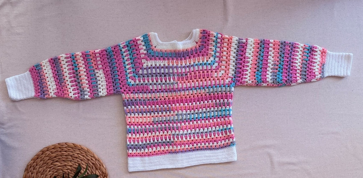 Full flat-lay back view of the handmade multicolour crochet cardigan showing the continuous striped pattern and overall proportions.