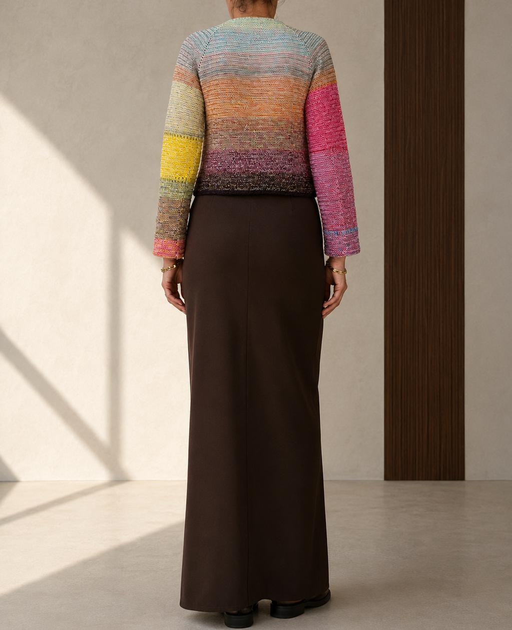 Full back view of the multicolour crochet cardigan showing the gradual transition from blue and green to deeper tones.