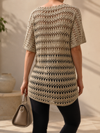 Back view of the taupe-grey openwork crochet tunic showing the repeating textured rows and softly curved hem.