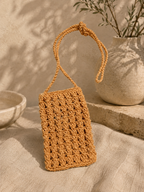 Orange handmade paper yarn crochet phone bag with a long crossbody strap.