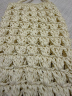 Close-up of the dense handmade crochet stitches in paper yarn.
