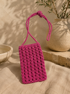 Pink handmade paper yarn crochet phone bag with a long crossbody strap.
