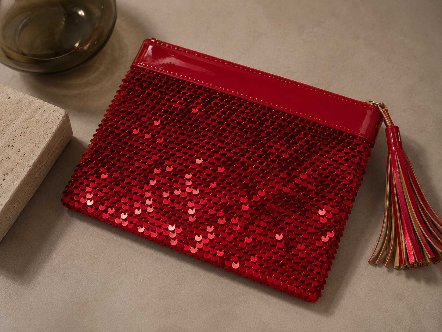 Flat lay view of the handmade red sequin clutch bag shown closed.