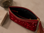 Open view of the handmade red sequin clutch bag showing the interior lining.