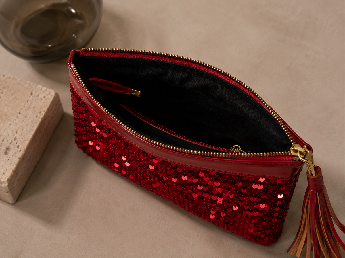 Open view of the handmade red sequin clutch bag showing the interior lining.