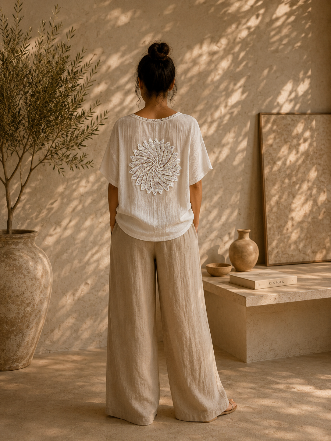 White round crochet lace motif shown on the back of a light blouse as a decorative application idea.