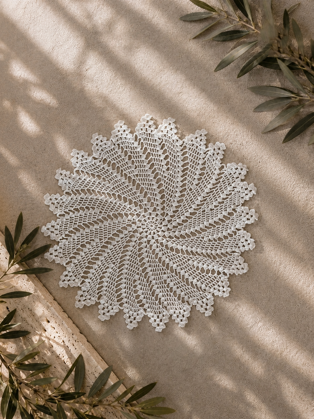 Handmade white round crochet lace motif with a radiating floral pattern and softly pointed outer edge.