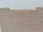 A close-up photo of a handmade crocheted blouse shows the neckline and the textured polyester yarn.