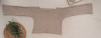 Flat-lay view of the sand-beige crochet blouse showing its broad cuff-to-cuff construction, wide shallow neckline and waist-length body.