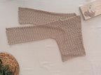 Full flat-lay view of the long-sleeve crochet blouse showing its straight shoulder construction, wide neckline and overall proportions.
