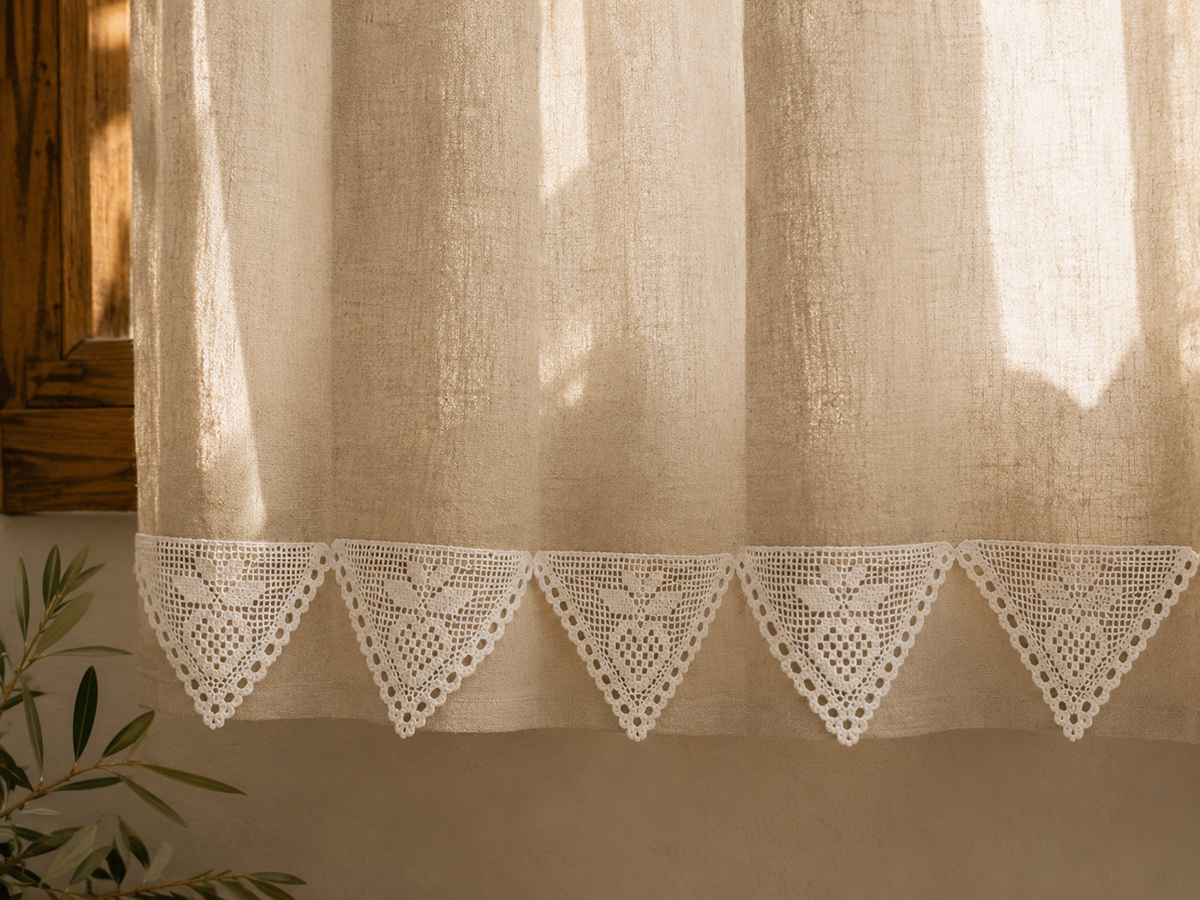 Styling example showing a row of white triangular crochet lace motifs along the lower edge of a curtain