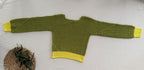 Full flat-lay view of the handmade green crochet jumper showing its long sleeves, pull-on construction, lime cuffs and matching hem.