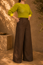 Full-length front view of the two-tone green yellow crochet jumper showing its long sleeves, openwork body and contrasting cuffs and hem.