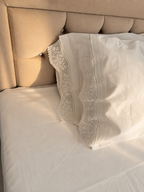 Close-up of the white plain-weave cotton fabric and handmade crochet lace used in the GOGOLI bed linen set.