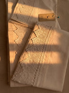 Folded white cotton bed linen set showing the crochet lace placement and clean piko-sarma finished edges.