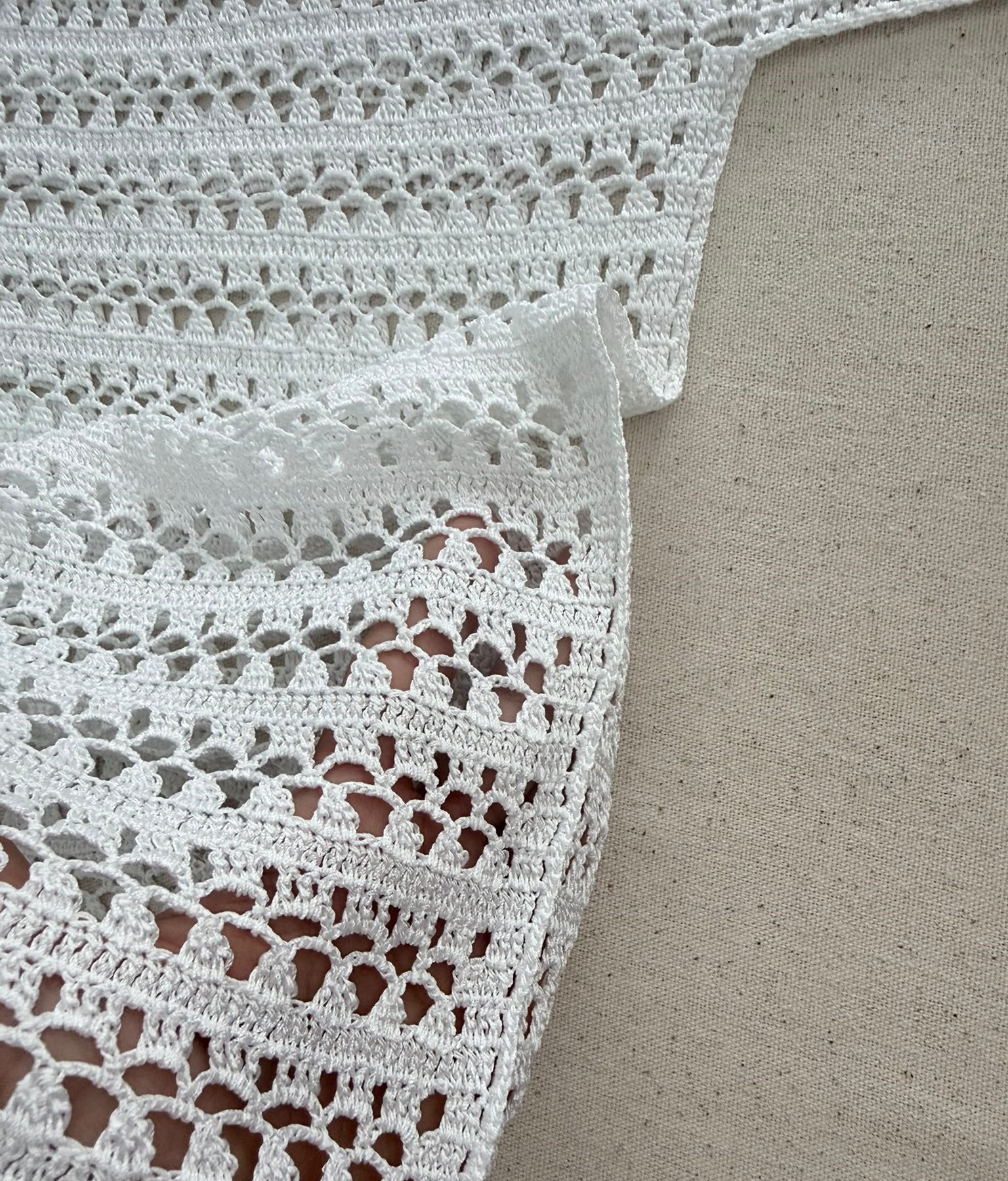 Close-up of the handmade crochet blouse showing the right-angle underarm construction and transition between body and sleeve.