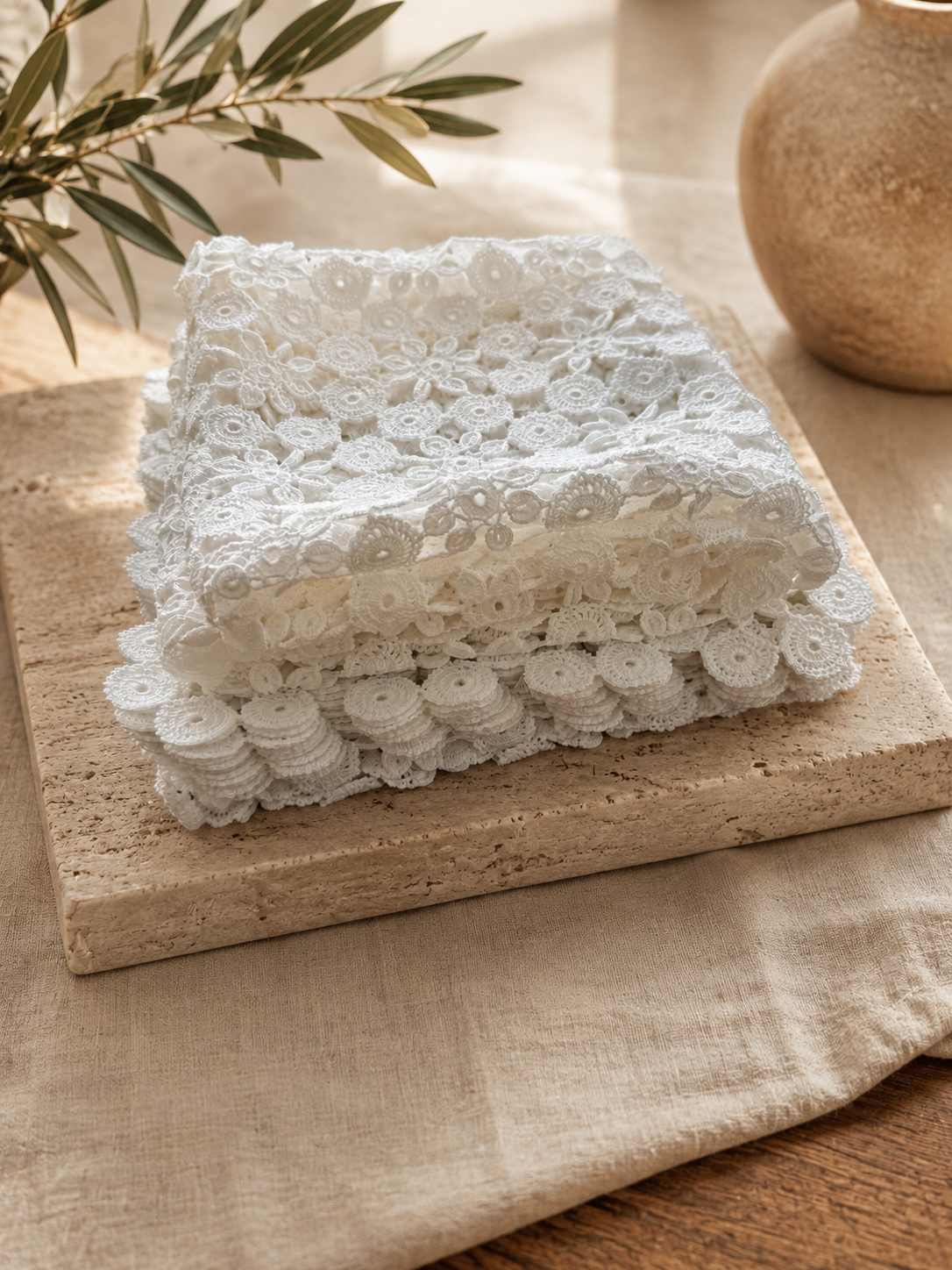 Folded arrangement of the thirteen-piece white crochet doily set, showing the layered lace edges and fine cotton texture.