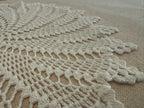 Detailed view of the repeating leaf-shaped sections within the handmade round crochet lace motif.