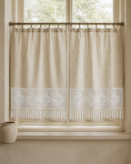 White floral crochet lace panel used as a decorative border on a neutral curtain