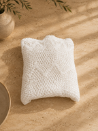 Handmade white crochet lace table topper folded into a compact square for storage.