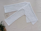 Full flat-lay view of the white crochet blouse showing its geometric T-shaped construction, boat neckline and right-angle underarms