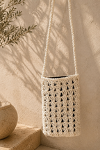 Front view of the white paper yarn crochet phone bag with a long crossbody strap.