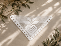 Handmade white triangular filet crochet lace motif crafted from fine mercerized cotton thread.
