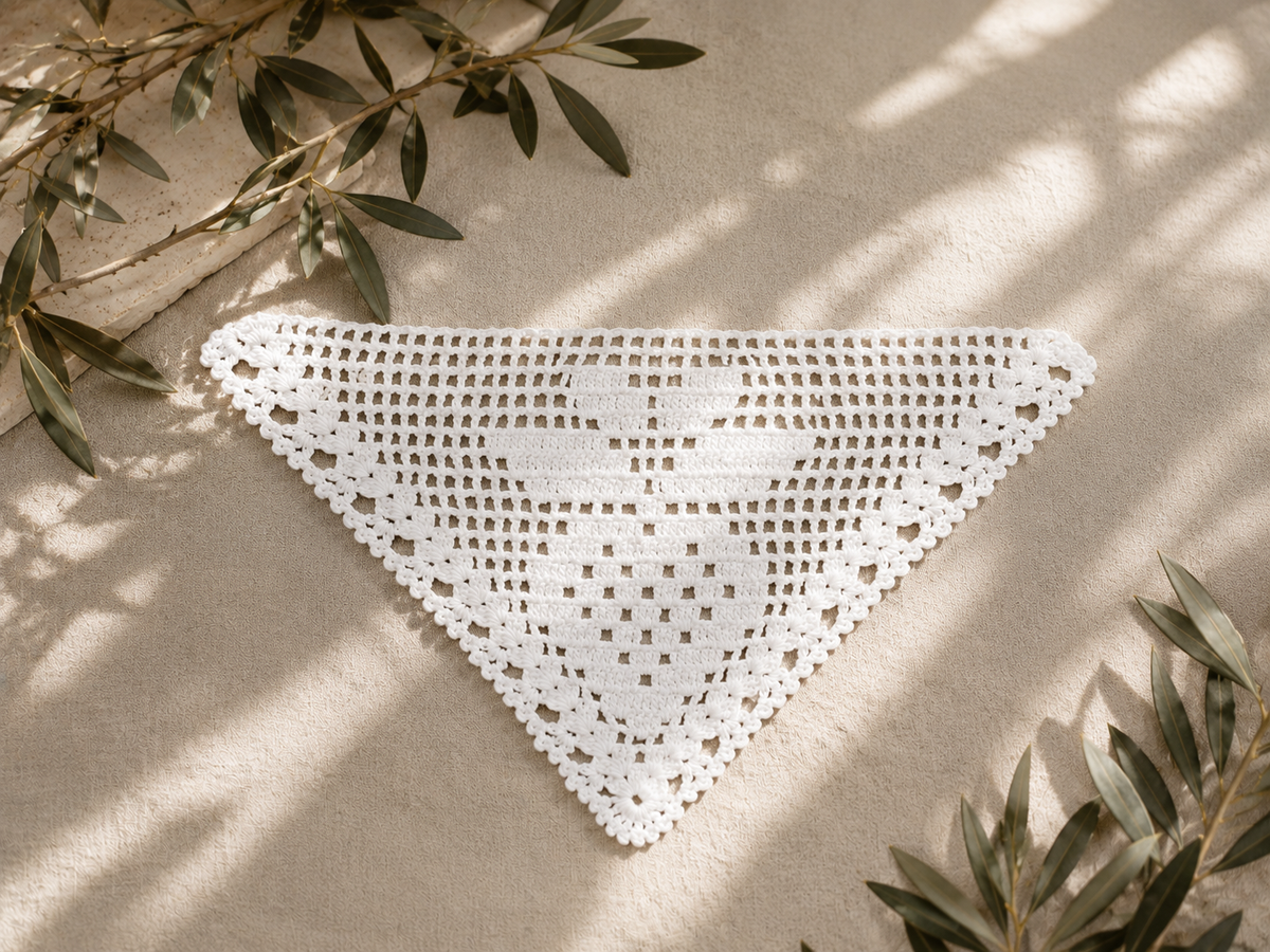 Handmade white triangular filet crochet lace motif crafted from fine mercerized cotton thread.